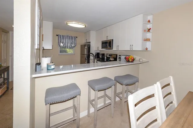 a kitchen with stainless steel appliances granite countertop a sink and cabinets