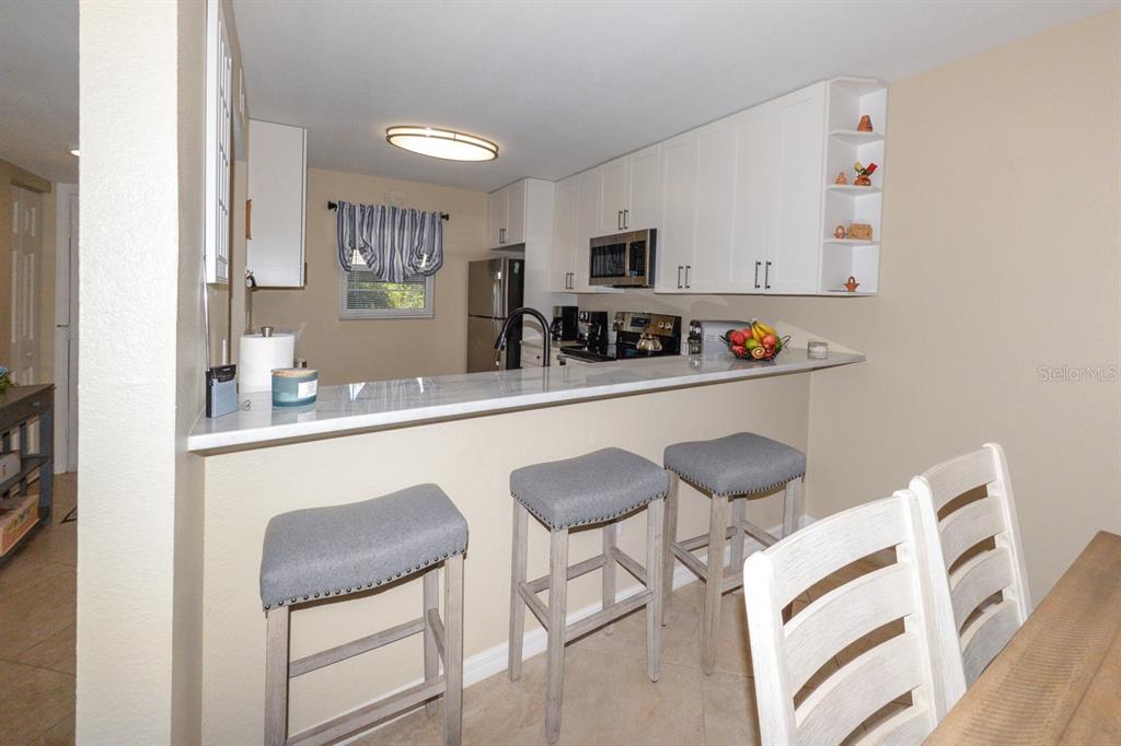 175 Kings Highway, Unit A7 Punta Gorda, FL 33983 - Photo 12 of 36 a kitchen with stainless steel appliances granite countertop a sink and cabinets