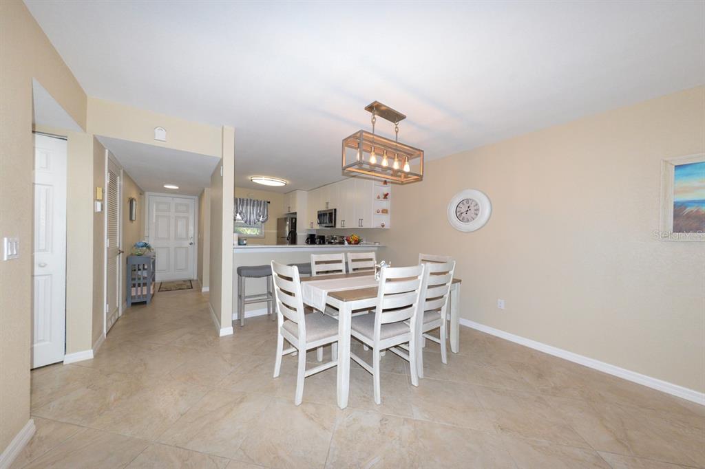 175 Kings Highway, Unit A7 Punta Gorda, FL 33983 - Photo 14 of 36 a view of a dining room with furniture and a chandelier