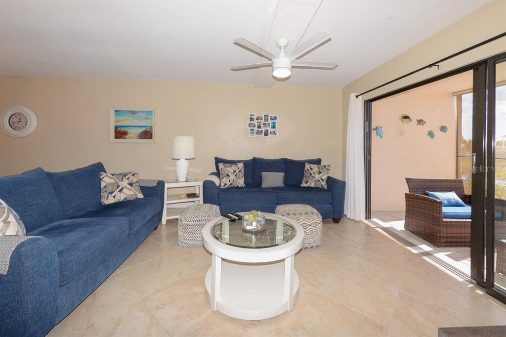 175 Kings Highway, Unit A7 Punta Gorda, FL 33983 - Photo 15 of 36 a living room with a couch and a flat screen tv
