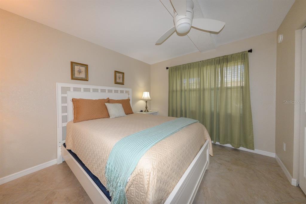 175 Kings Highway, Unit A7 Punta Gorda, FL 33983 - Photo 19 of 36 a bedroom with a bed and a chandelier