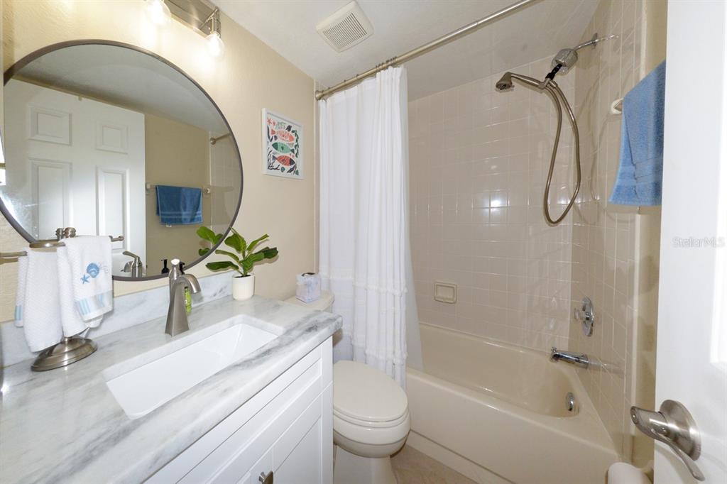 175 Kings Highway, Unit A7 Punta Gorda, FL 33983 - Photo 22 of 36 a bathroom with a granite countertop sink a toilet and shower