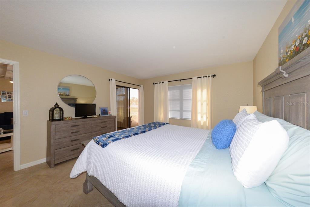 175 Kings Highway, Unit A7 Punta Gorda, FL 33983 - Photo 25 of 36 a bedroom with a large bed and a window