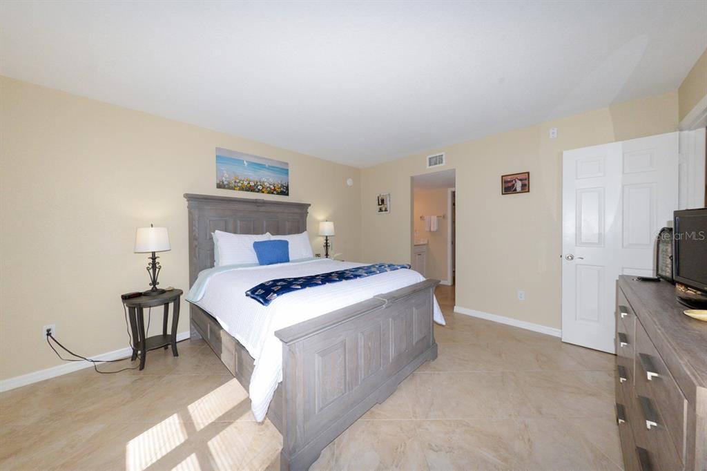175 Kings Highway, Unit A7 Punta Gorda, FL 33983 - Photo 26 of 36 a bedroom with a bed and a television