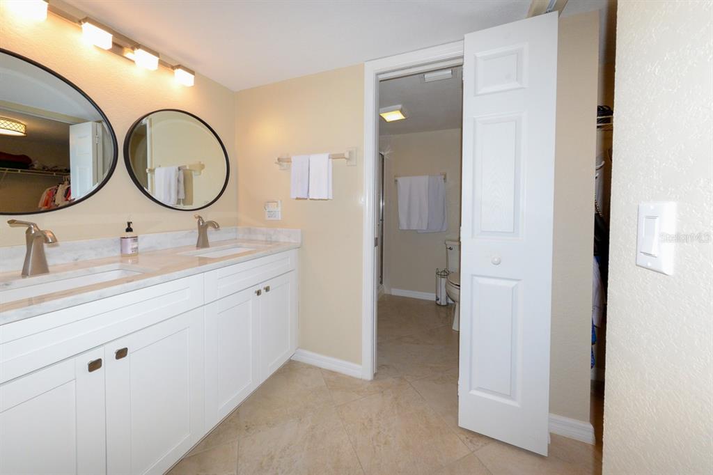 175 Kings Highway, Unit A7 Punta Gorda, FL 33983 - Photo 28 of 36 a bathroom with a double vanity sink and a mirror
