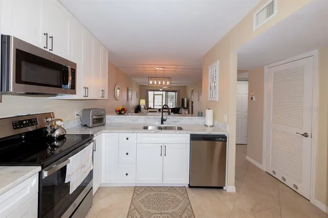 a kitchen with a sink stove and microwave