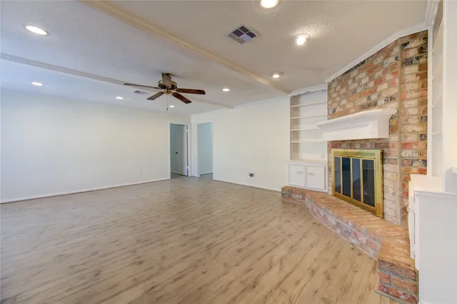 a view of an empty room with a fireplace