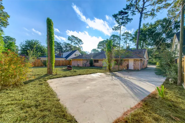 a front view of a house with a yard and a garden