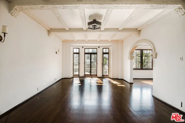 a view of an entryway with a floor to ceiling window and wooden floor