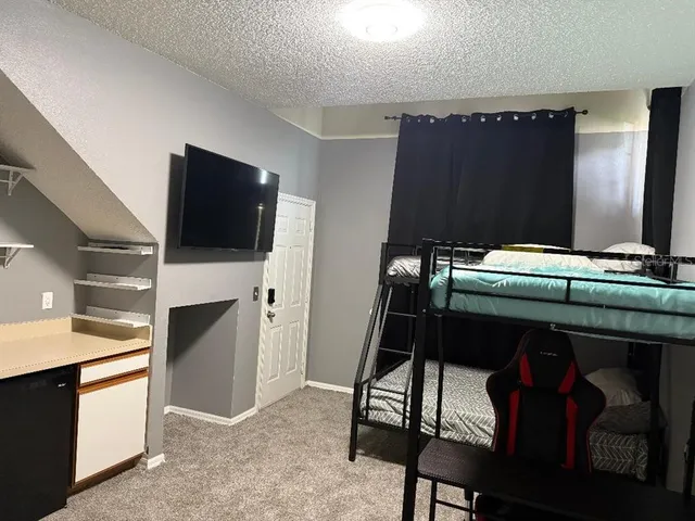 a bedroom with furniture and a air conditioner vent