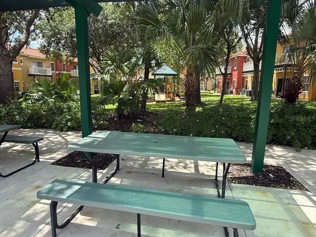a view of a swimming pool with sitting area and slide