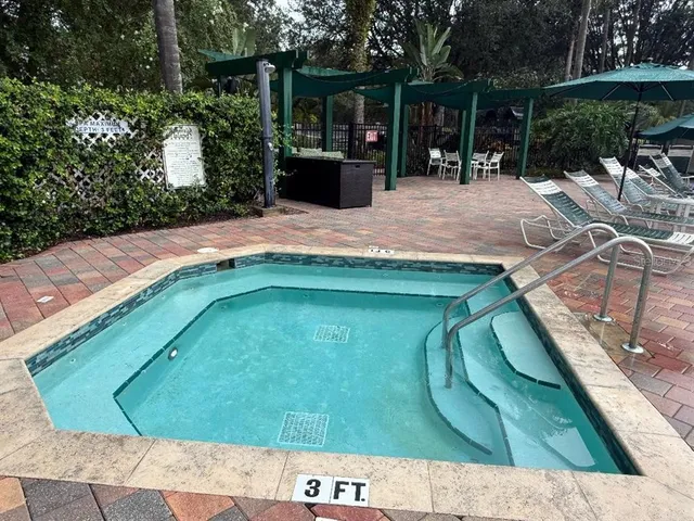 a sign board with a yard and trees in the back