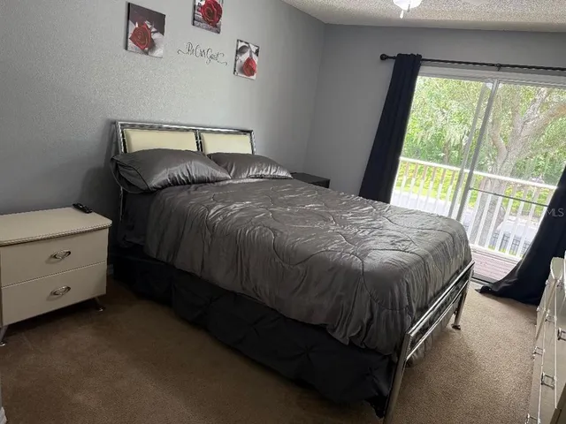 a bed sitting in a bedroom next to a window