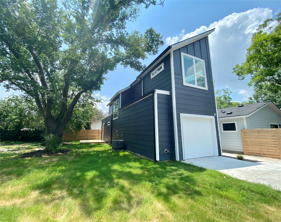 2500 Sweeney Lane, Unit B BACK HOUSE Austin, TX 78723 - Photo 2 of 17 a view of backyard with large tree and wooden fence