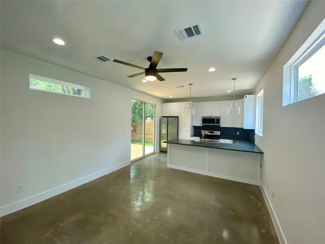 a view of a kitchen with a sink and a window