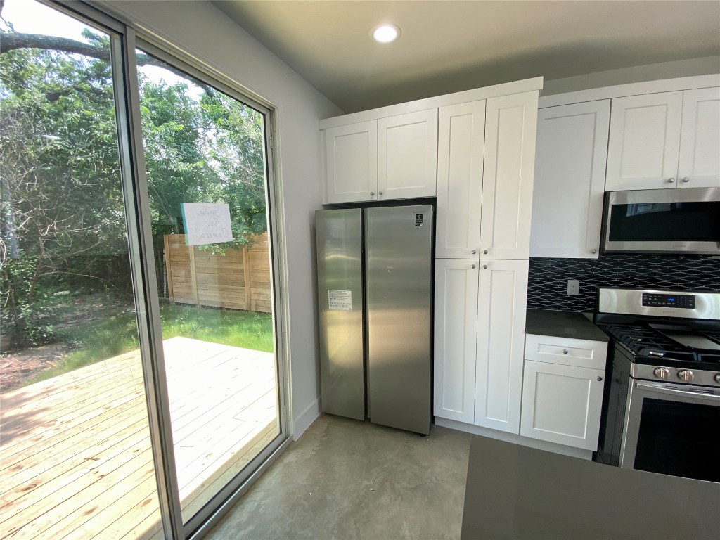 2500 Sweeney Lane, Unit B BACK HOUSE Austin, TX 78723 - Photo 5 of 17 a kitchen with stainless steel appliances granite countertop a refrigerator and a sink