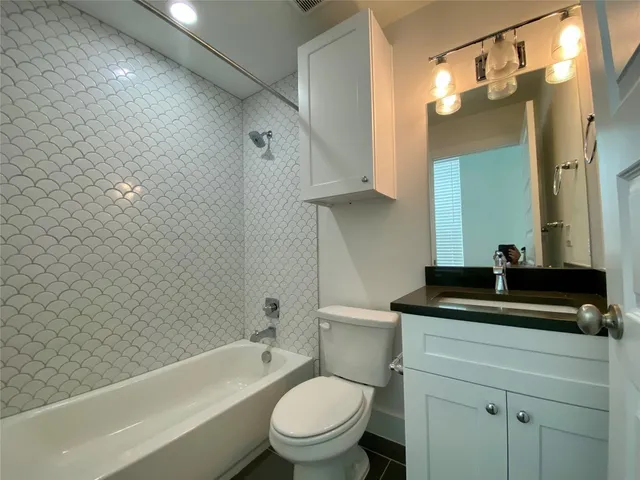 a bathroom with a sink a toilet and a bathtub