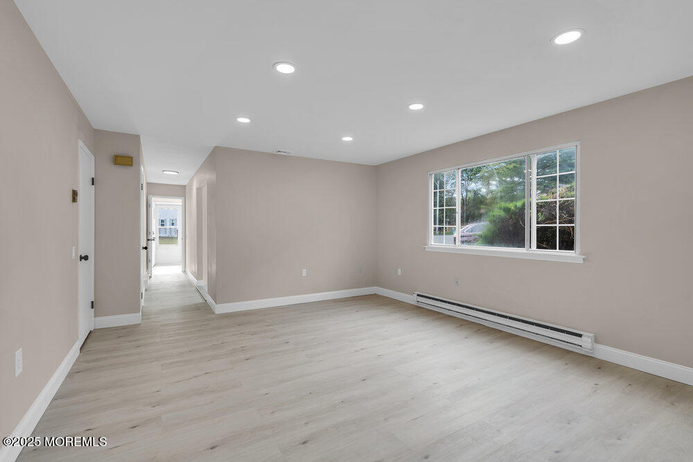 9B Juniper Lane, Unit 50 Whiting, NJ 08759 - Photo 11 of 28 an empty room with wooden floor and windows
