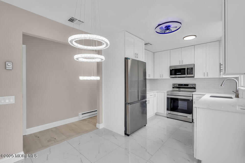 9B Juniper Lane, Unit 50 Whiting, NJ 08759 - Photo 13 of 28 a kitchen with a refrigerator and a sink