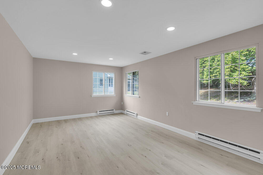9B Juniper Lane, Unit 50 Whiting, NJ 08759 - Photo 20 of 28 an empty room with wooden floor and windows