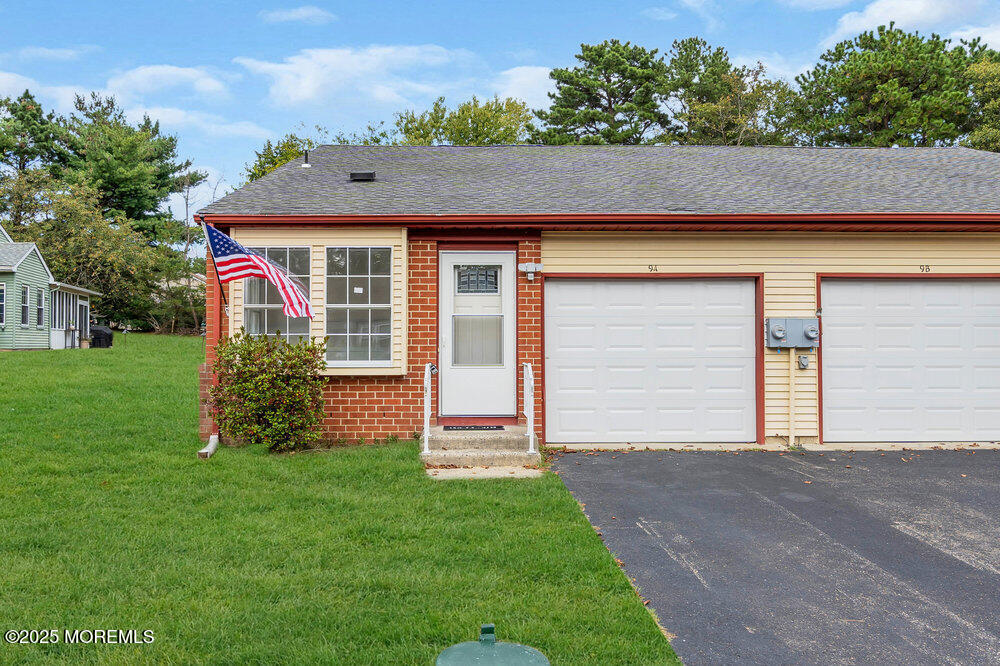 9B Juniper Lane, Unit 50 Whiting, NJ 08759 - Photo 2 of 28 a view of a house with a small yard plants and large tree