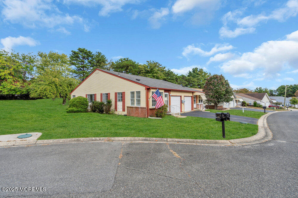 9B Juniper Lane, Unit 50 Whiting, NJ 08759 - Photo 3 of 28 a front view of a house with a yard and garage