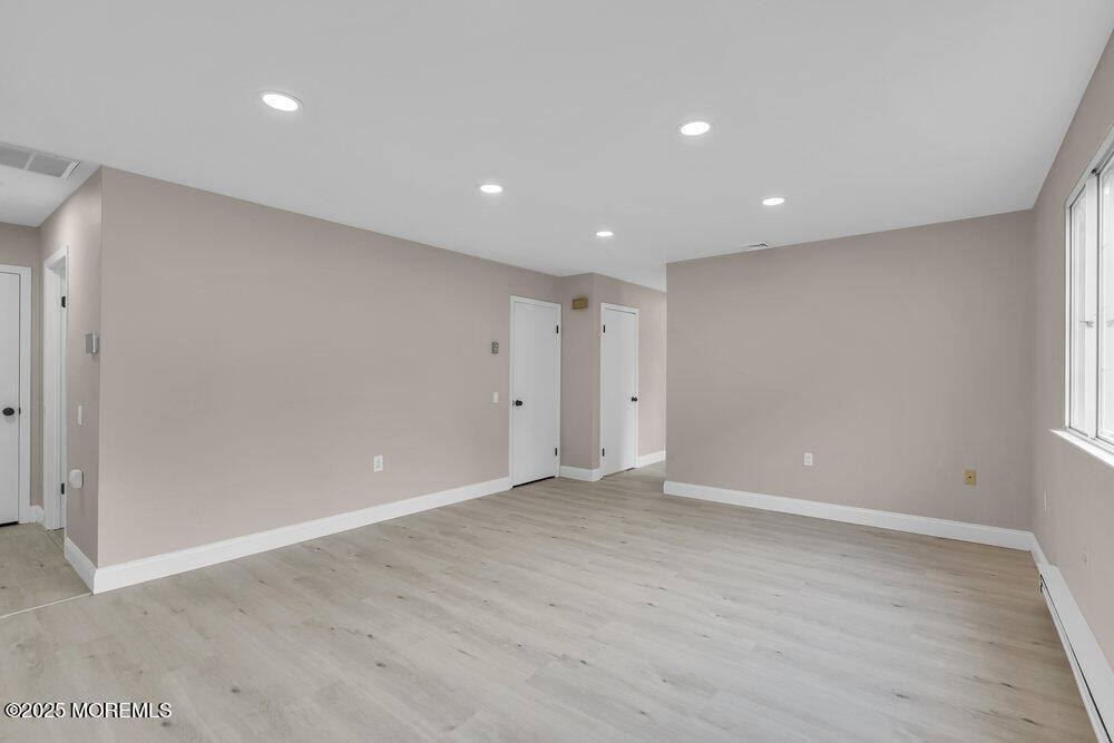 9B Juniper Lane, Unit 50 Whiting, NJ 08759 - Photo 8 of 28 an empty room with wooden floor and windows