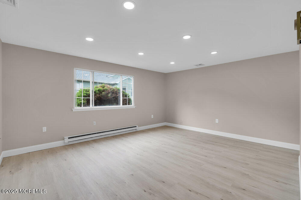 9B Juniper Lane, Unit 50 Whiting, NJ 08759 - Photo 10 of 28 an empty room with wooden floor and windows