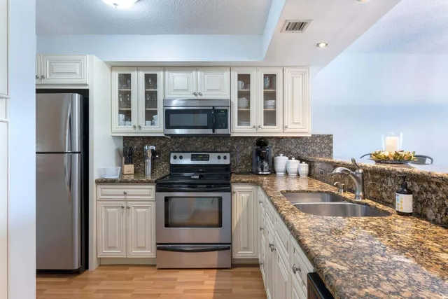 a bathroom with a sink toilet a mirror and shower