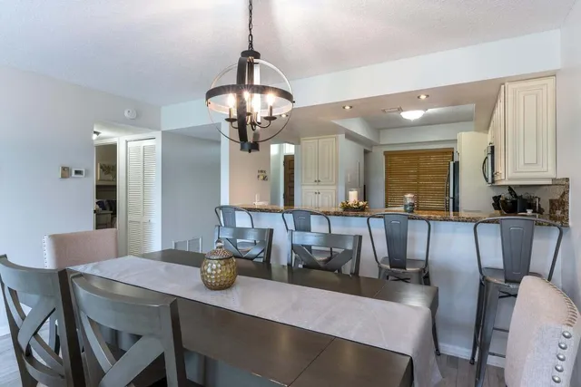 a living room with furniture and a large window with wooden floor