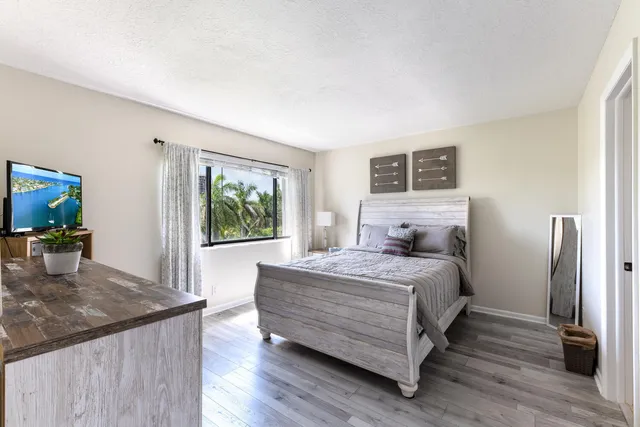 a bedroom with a large bed and a window