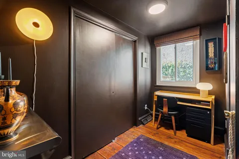 a view of a workspace with furniture and a window