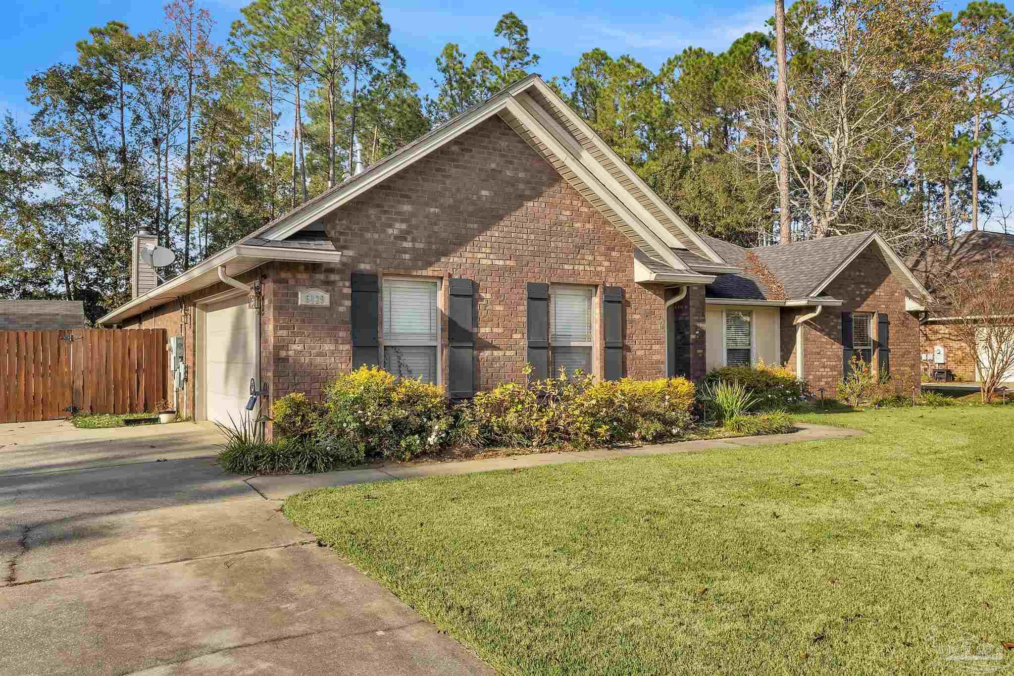6129 Stonechase Boulevard Pace, FL 32571 - Photo 12 of 57 a front view of a house with a garden