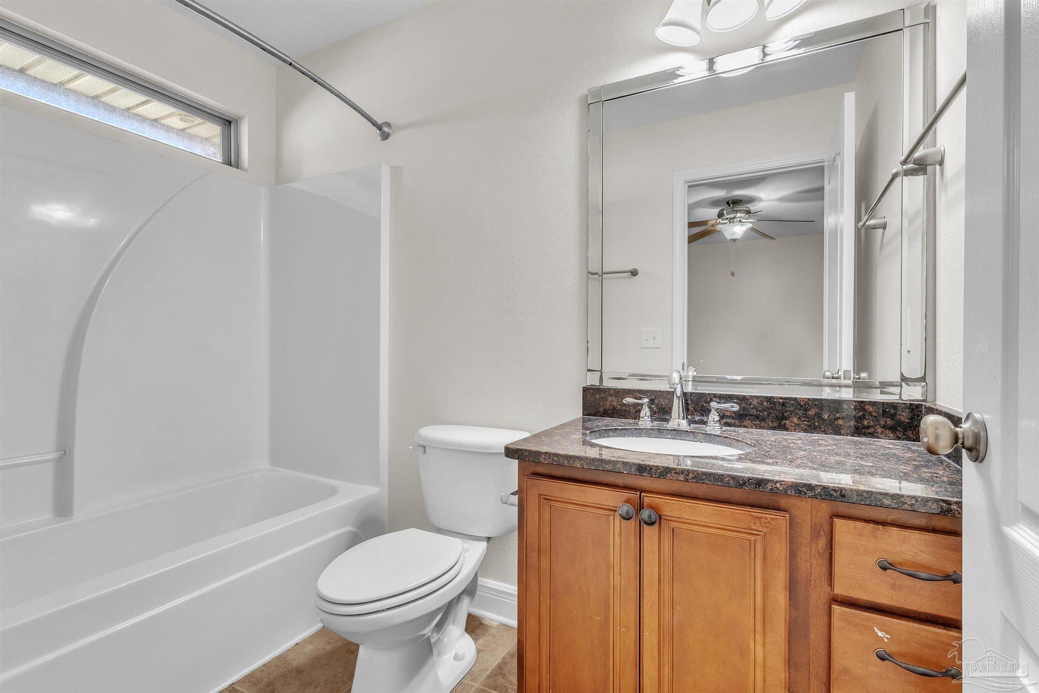 6129 Stonechase Boulevard Pace, FL 32571 - Photo 25 of 57 a bathroom with a granite countertop sink toilet and shower