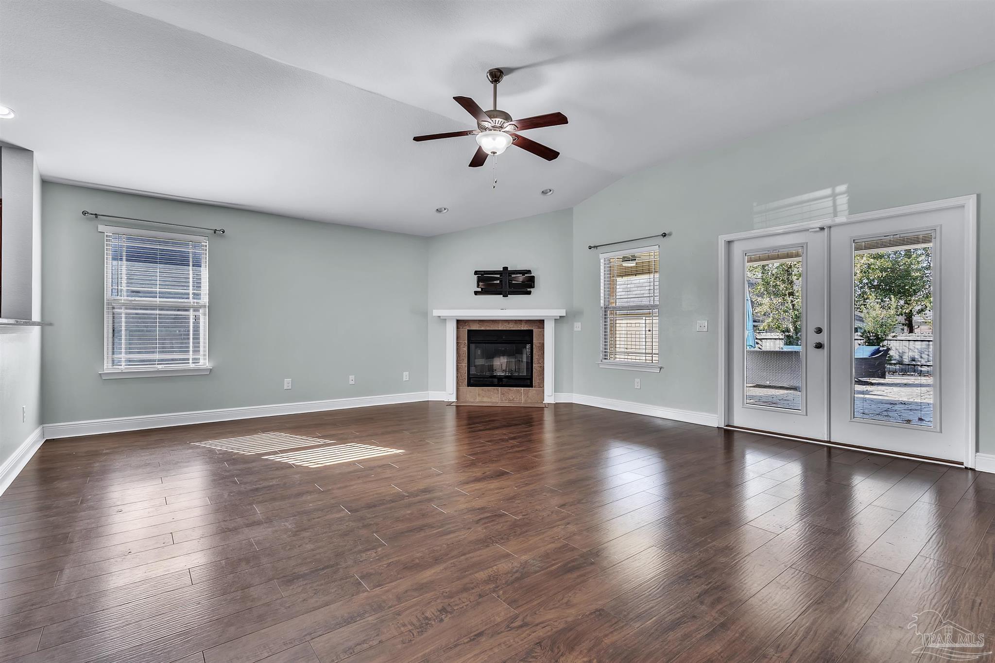 6129 Stonechase Boulevard Pace, FL 32571 - Photo 35 of 57 a view of an empty room with wooden floor fireplace and a window