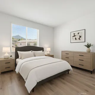 a bedroom with a bed and a window