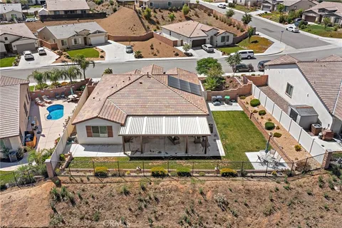 an aerial view of a house with a yard