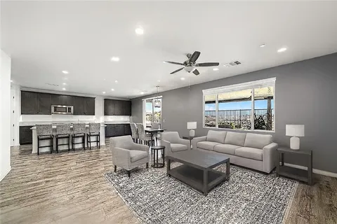 a living room with furniture and view of kitchen