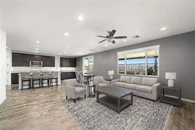 a living room with furniture and view of kitchen
