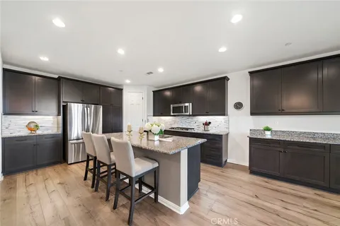 a kitchen with stainless steel appliances kitchen island granite countertop a sink and cabinets