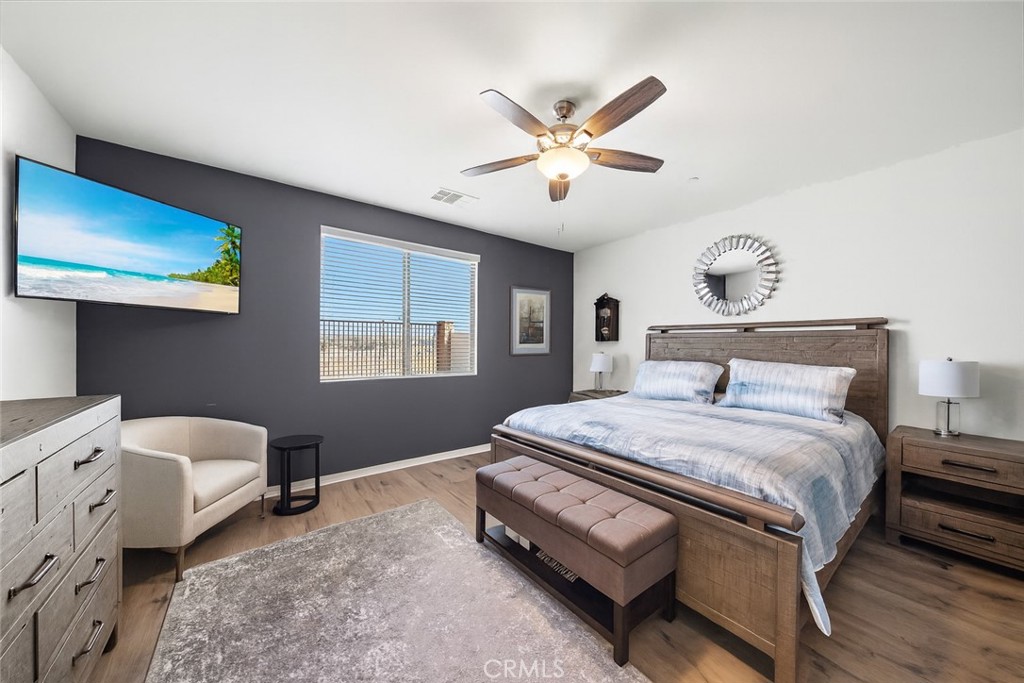 1537 Yucca Court Calimesa, CA 92320 - Photo 8 of 16 a bedroom with a bed and a chandelier