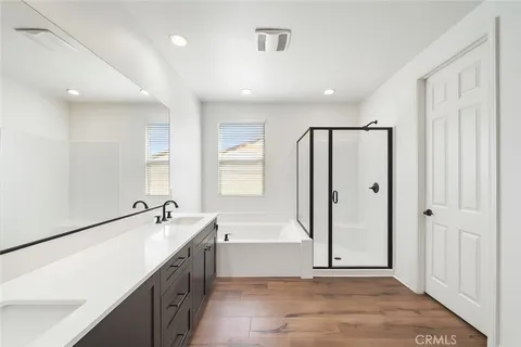 a spacious bathroom with a tub a sink and mirror