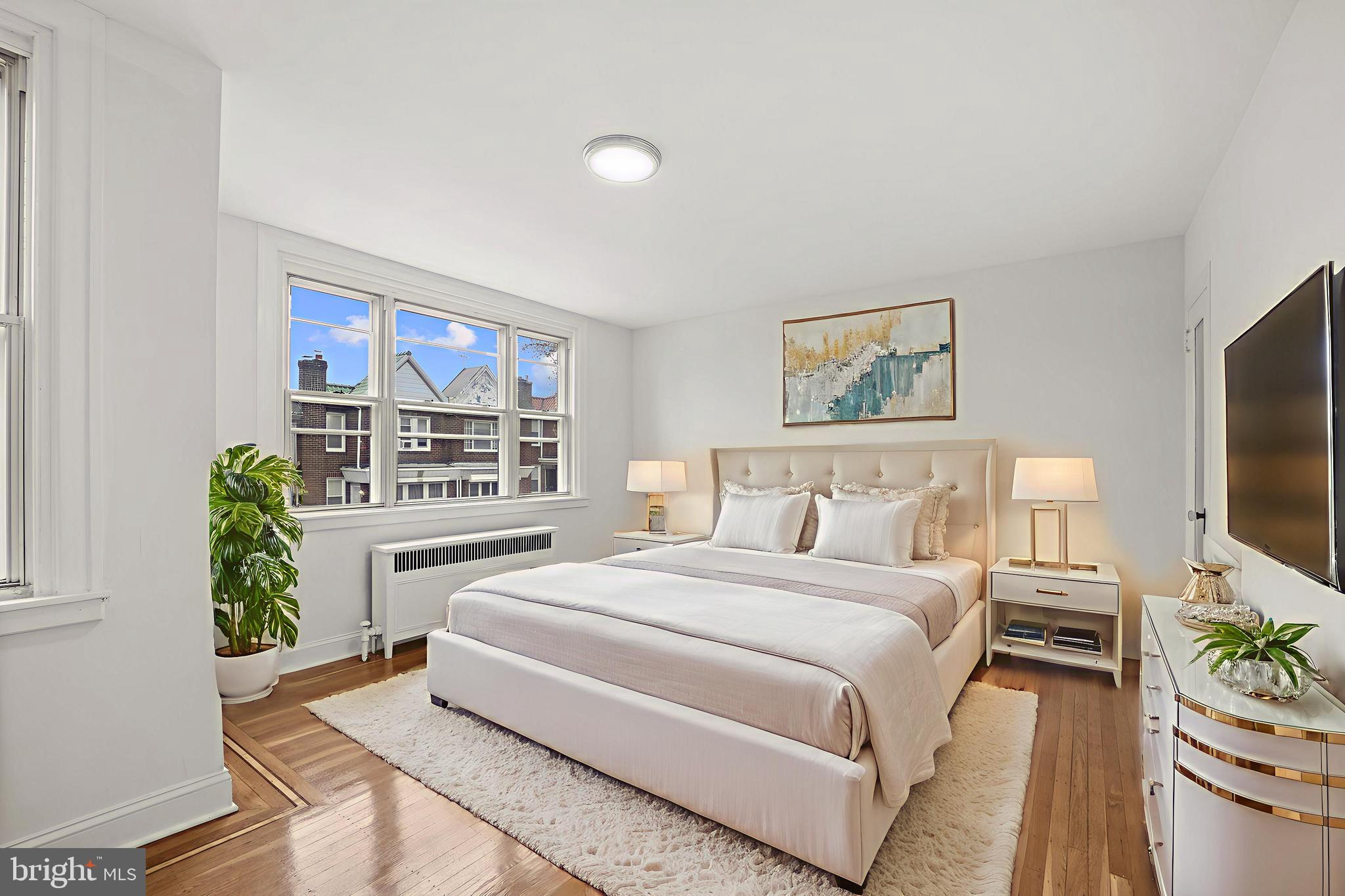 1969 Ashley Road Philadelphia, PA 19138 - Photo 9 of 12 a spacious bedroom with a large bed and a flat screen tv