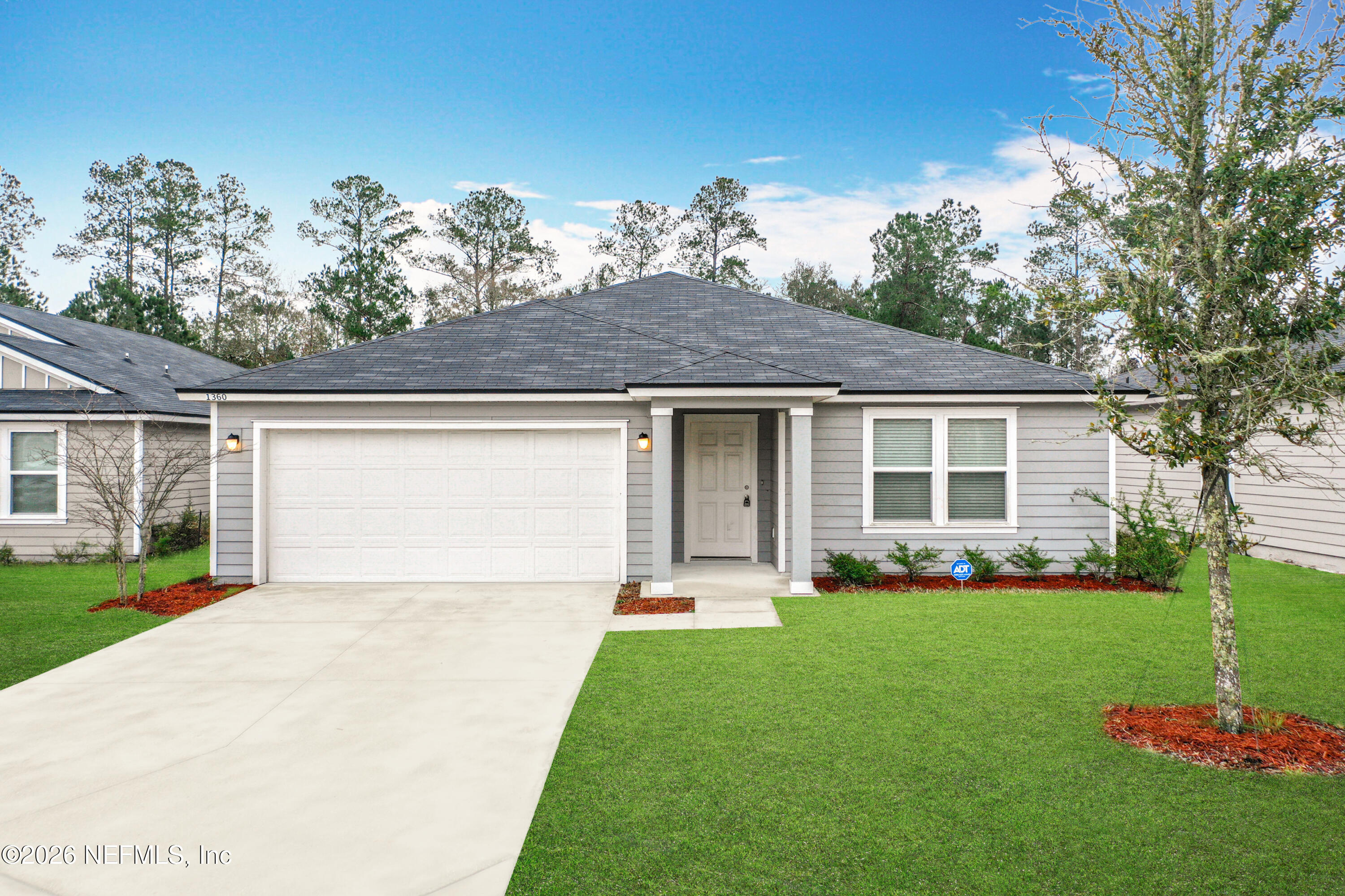 1360 Tan Tara Trail Jacksonville, FL 32221 - Photo 1 of 23 a front view of a house with a garden and yard