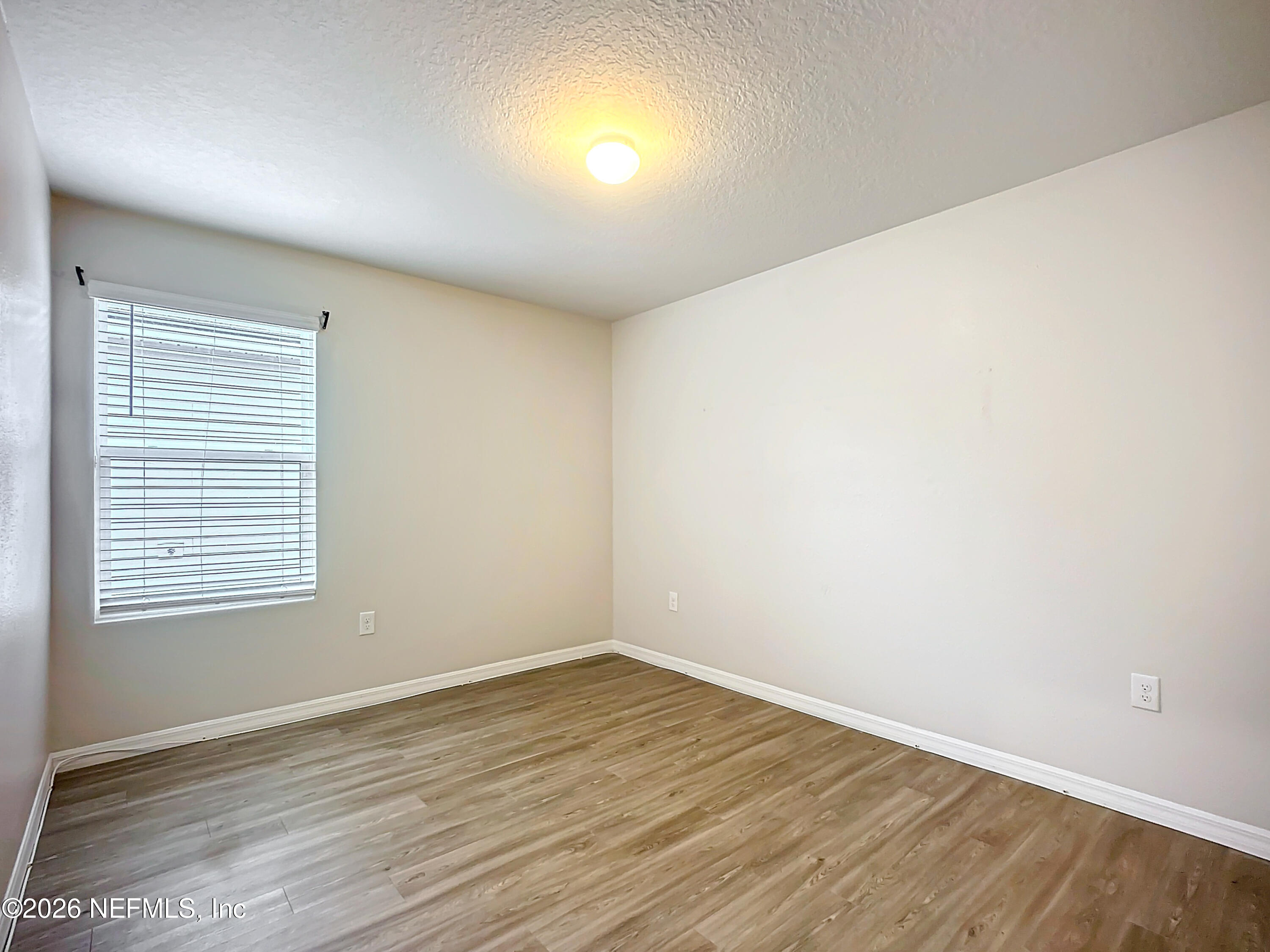 1360 Tan Tara Trail Jacksonville, FL 32221 - Photo 11 of 23 an empty room with wooden floor and windows