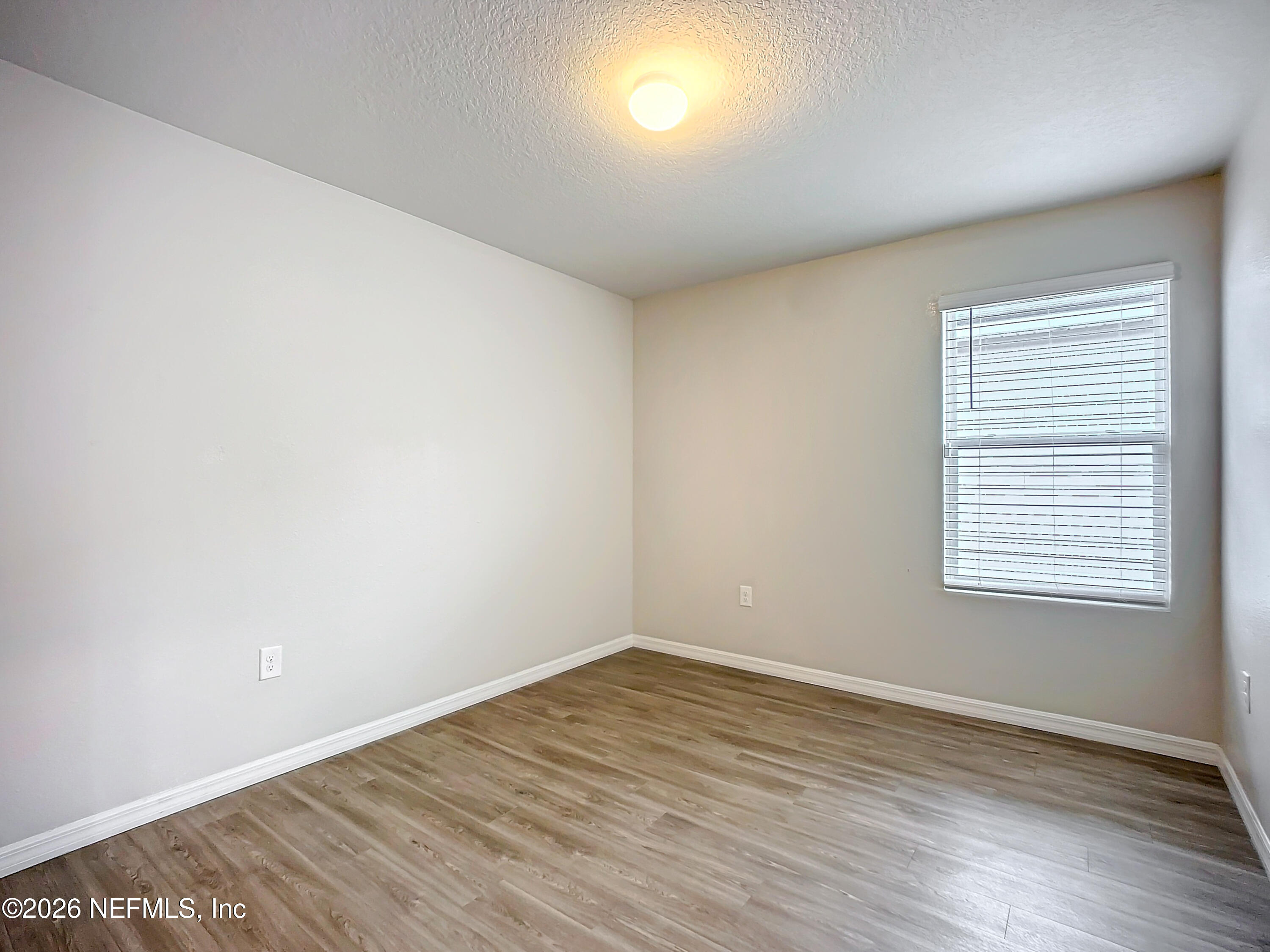 1360 Tan Tara Trail Jacksonville, FL 32221 - Photo 13 of 23 an empty room with wooden floor and windows