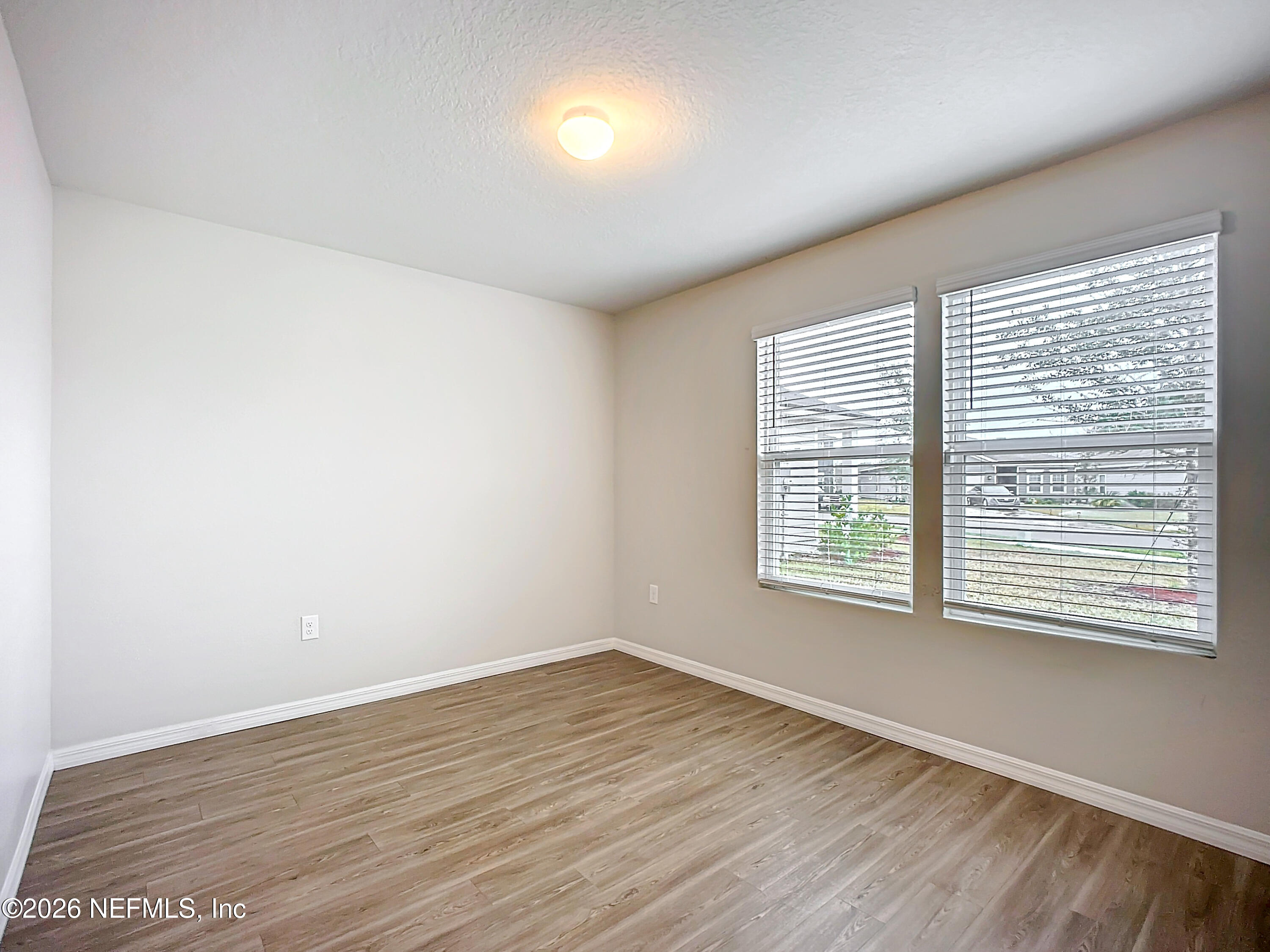 1360 Tan Tara Trail Jacksonville, FL 32221 - Photo 15 of 23 a view of an empty room with wooden floor and a window