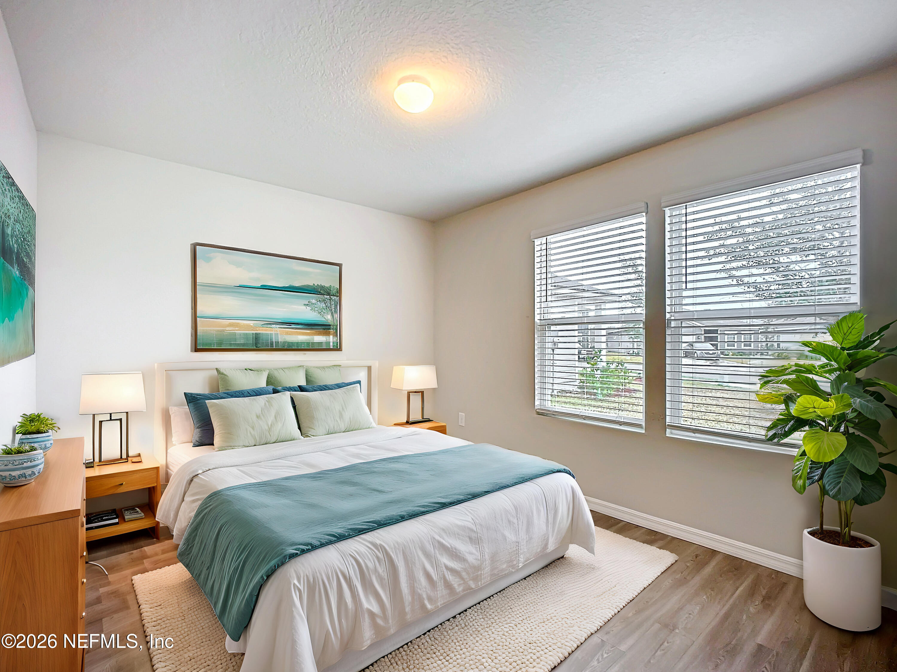 1360 Tan Tara Trail Jacksonville, FL 32221 - Photo 16 of 23 a bedroom with a large bed and a potted plant