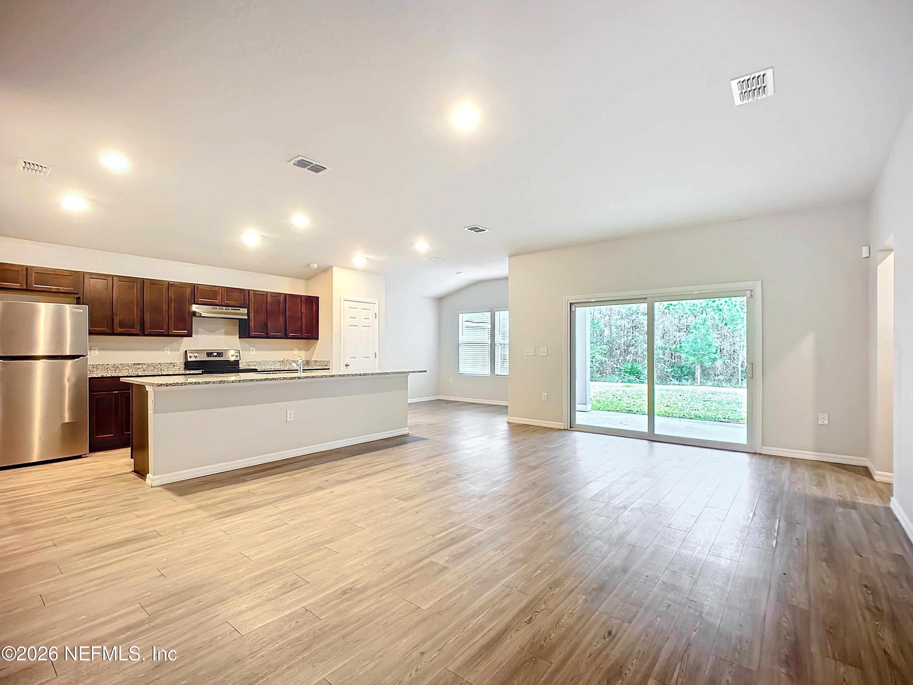 1360 Tan Tara Trail Jacksonville, FL 32221 - Photo 3 of 23 a large kitchen with stainless steel appliances granite countertop a large counter top and a wooden floors