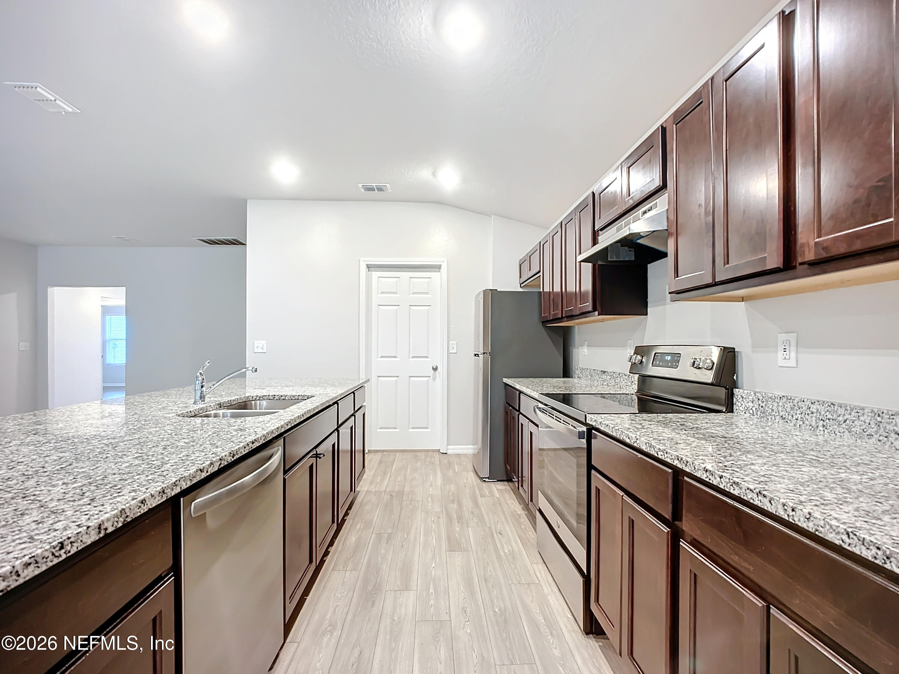 1360 Tan Tara Trail Jacksonville, FL 32221 - Photo 5 of 23 a kitchen with granite countertop stainless steel appliances and wooden cabinets